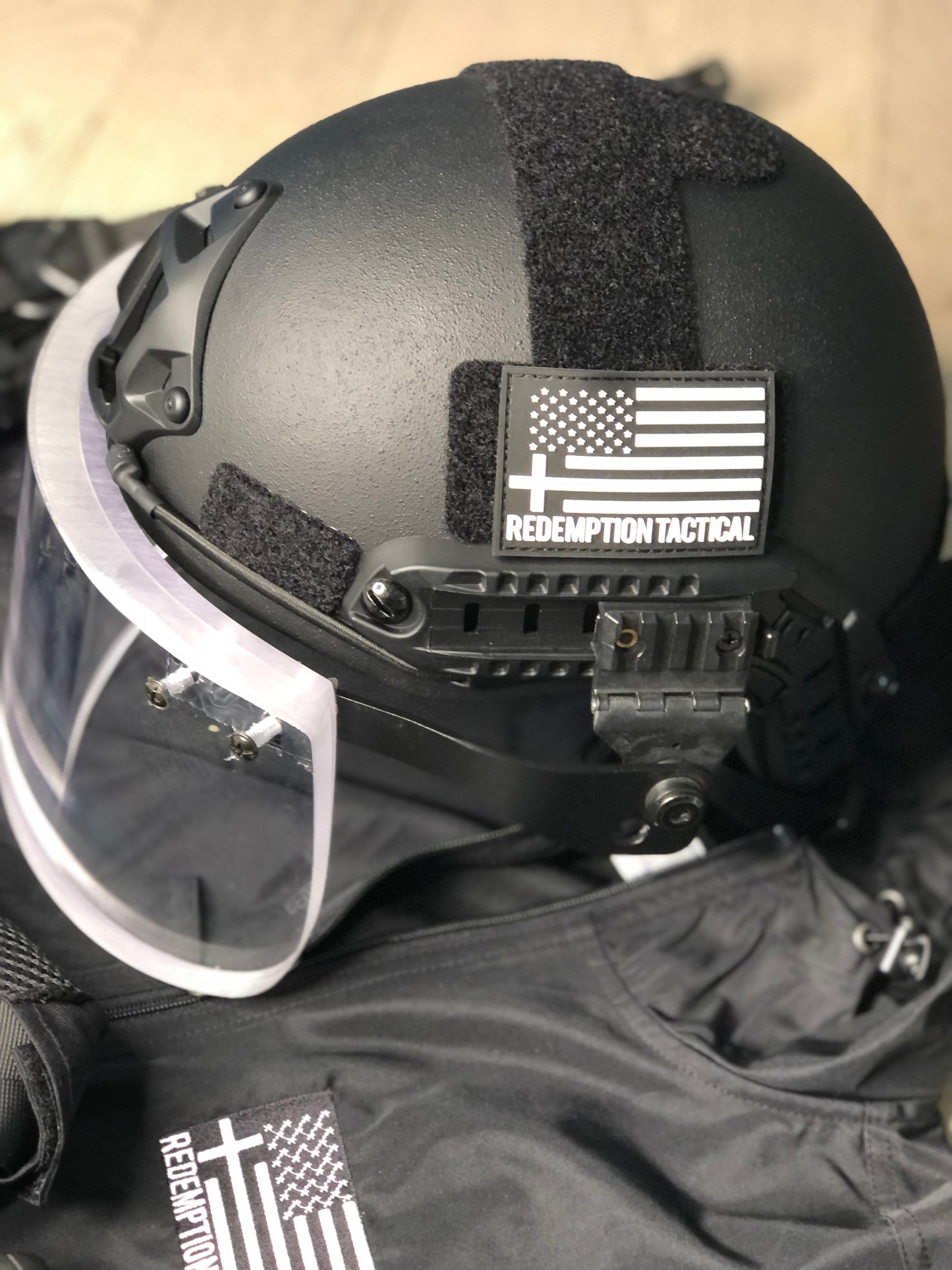 Ballistic Face Shield for helmets with ARC rail mounts, providing protection against 9mm threats while ensuring clear visibility, includes protective cover bag