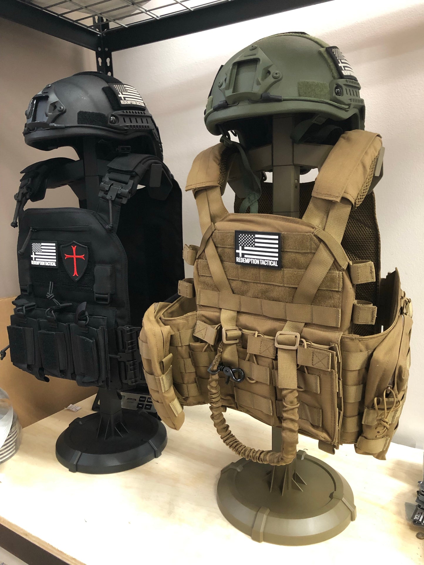 Armor Butler Stand 2.0 by Green Tip Surplus for displaying tactical gear, including body armor, battle belts, and helmets. The stand is customizable in size and configuration, perfect for quick deployment and showcasing your gear. Available in black and coyote brown.