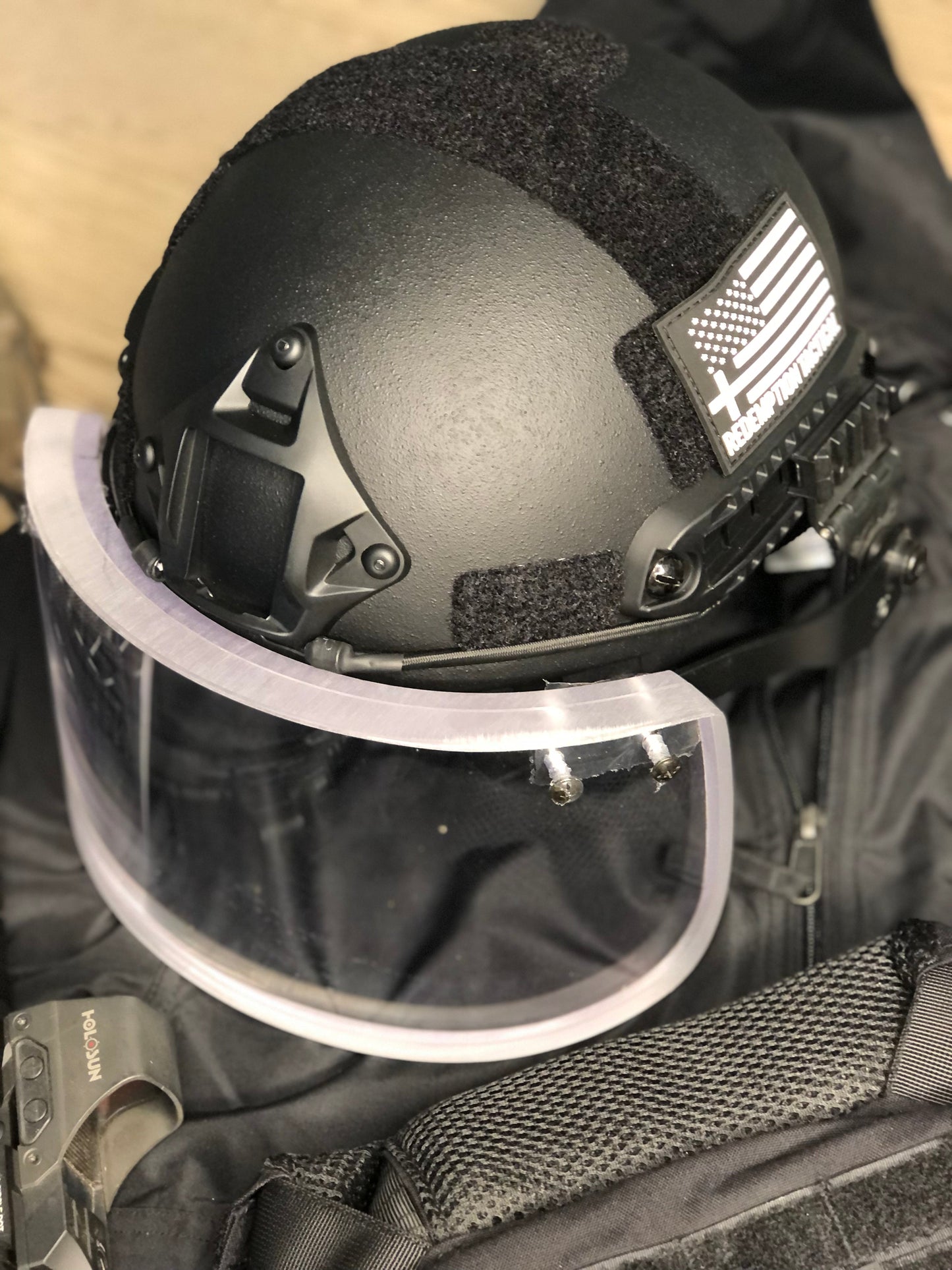 Level IIIA Ballistic Glass Face Shield with Helmet ARC Rail Mount, designed for full-face protection while maintaining visibility, tested to NIJ 9mm standards
