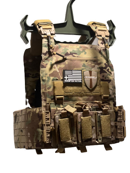 Redemption Tactical CRUSADER 2.0 XL Plate Carrier Vest in Multicam featuring quick-release shoulder and waist buckles for fast removal in emergencies. Includes triple double-stack mag pouch on the front with room for 3 AR and 3 pistol magazines. Built with laser-cut MOLLE for tight gear attachment, a zippered admin pouch, side cummerbunds with adjustable Velcro closure, and side plate pockets that fit 6x6, 6x8, or 8x6 armor plates. Interior includes anti-sweat black mesh pads for ventilation and plate pouch